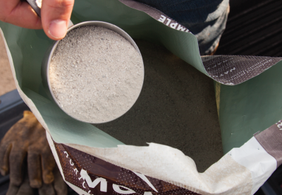 Farmer scooping Redmond volcanic Conditioner